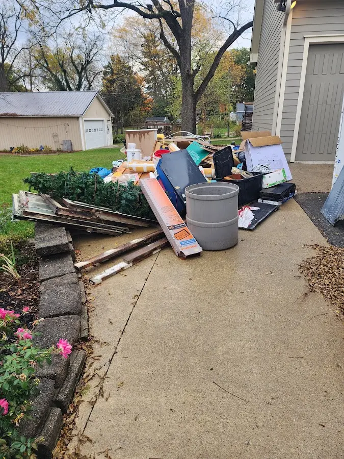 Dumpster being loaded with debris for Commercial Dumpster Rental in Lake Villa
